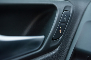 Obraz na płótnie Canvas Close-up car door lock button. Car door lock button icon. Child protection.