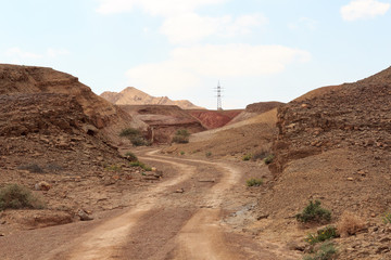 Off-Road path and mountain in crater Makhtesh Ramon, Negev Desert, Israel