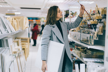 Adult pretty female shopping in stationery store