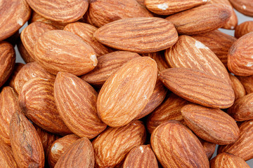 Fototapeta premium macro almond nuts on a white background