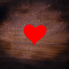 Red paper heart isolated on wooden background