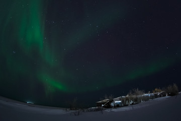 Aurora borealis in night northern sky. Ionization of air particles in the upper atmosphere.