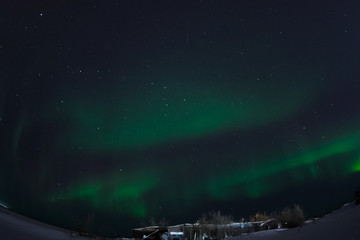 Aurora borealis in night northern sky. Ionization of air particles in the upper atmosphere.