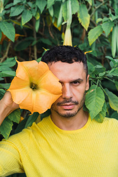 Portrait of man with blossom of angel's trumpet