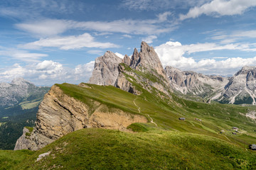 Fototapeta na wymiar Beautiful blue sky and white clouds over the seceda summit at the amazing Val Gardena valley in Dolomites mountains, Alps, Italy.