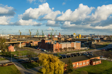 Fototapeta na wymiar View of the shipyard and port - industry part of the city of Gdansk (Gdańsk) with shipyard constructions and cranes. Poland