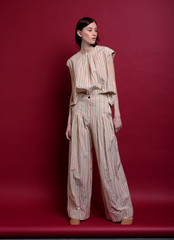 Naklejka premium Fashionable photo. Girl model in fashionable clothes, studio shooting.