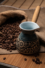 Coffee still life. Coffee beans, burlap and beautiful сezve