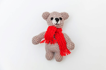 Simply minimal design with toy bear in red scarf isolated on white background. Children care materinity family concept. Flat lay, top view, copy space