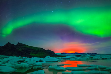 Aurora borealis in night northern sky. Ionization of air particles in the upper atmosphere.