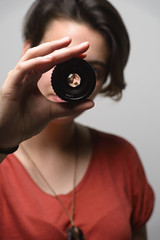 young woman with photographic lens