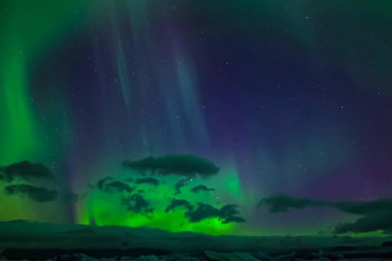 Naklejka premium Aurora borealis in night northern sky. Ionization of air particles in the upper atmosphere.