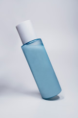 blue cosmetic bottle on a white tabl