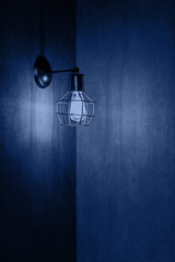 Lamp in loft style on the background of dark walls.