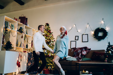 Cheery couple dancing on Christmas day