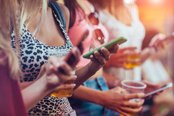 Close up of women holding smartphones