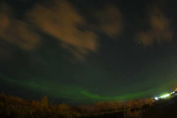Fototapeta premium Aurora borealis in night northern sky. Ionization of air particles in the upper atmosphere.