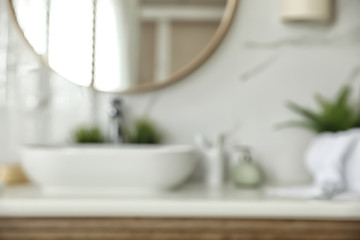 Blurred view of stylish modern bathroom with mirror