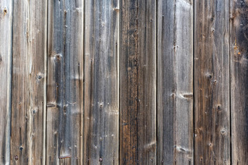 Old wooden planks with gaps between them close