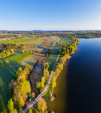 Germany, Bavaria, Uffing am Staffelsee, Aerial view of country road stretching between river Ach and shore of Staffelsee lake