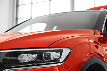 Obraz na płótnie Canvas New luxury car in modern auto dealership, closeup