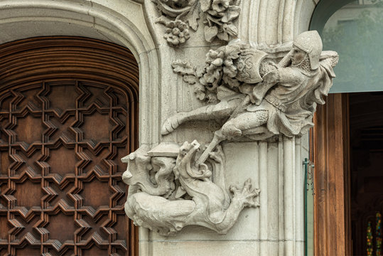 Saint George and the dragon detail in facade  Representation in low relief of St. George and the dragon in a column at the entrance of a building in Barcelona, Spain