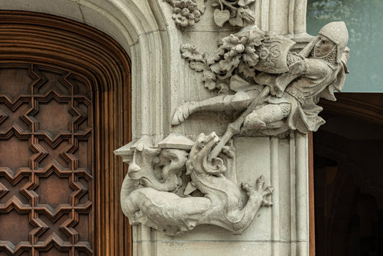 Saint George and the dragon detail in facade  Representation in low relief of St. George and the dragon in a column at the entrance of a building in Barcelona, Spain