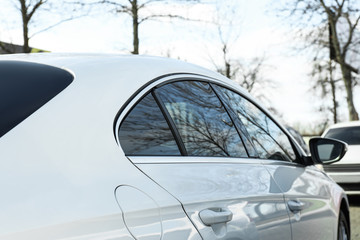 Modern car with tinting foil on window outdoors, closeup