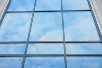 Modern building with tinted windows, low angle view. Urban architecture