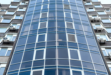 Fototapeta na wymiar Modern building with tinted windows, low angle view