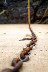 Rusty chains on the sand
