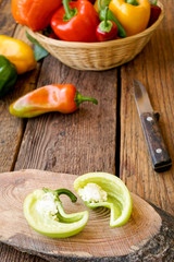 sliced bell peppers on wooden background