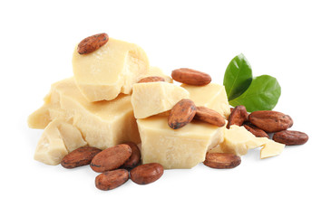 Organic cocoa butter, beans and green leaves isolated on white