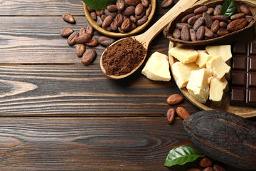 Flat lay composition with organic cocoa butter on wooden table. Space for text