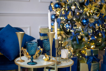 Blue glass and gold metallic holiday glasses, New Year's dinner, decor in blue and gold colors...
