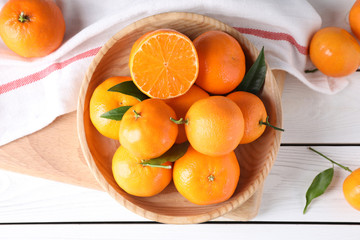 Fresh ripe tangerines on white wooden table, flat lay