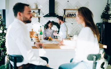 Fototapeta premium Couples talking at Christmas party