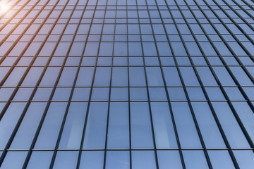 endless glass and steel wall of skyscraper, modern building architecture of business center, abstract curved lines with sunlight