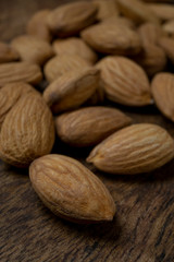 Almond lies on a wooden table close-up