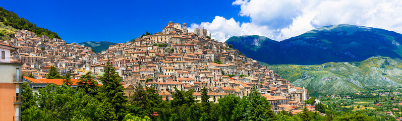 Obraz premium Morano Calabro Italy 11k panorama of beautiful medieval village on hill. Scenic landscape of Calabria with ancient stone houses on hillside and green mountains. Traditional Italian borgo scenery