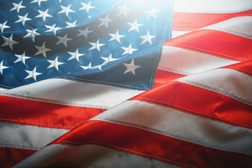 USA flag background. Waving American flag in sunlight flare, close up, vintage toned