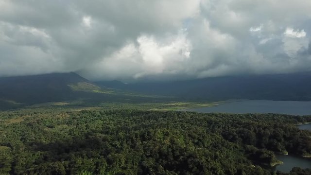 Aerial images of the beautiful landscape on Lake Arenal, Costa Rica, with the Volcano and the lake in the background in a cloudy day.