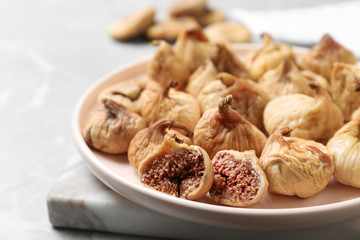 Fototapeta premium Tasty dried figs on light grey table, closeup