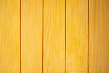 Fototapeta premium Old yellow wooden planks background close up