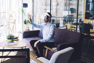 Man in VR headset interacting with virtual object