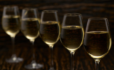 white wine on a black wooden background, close up.