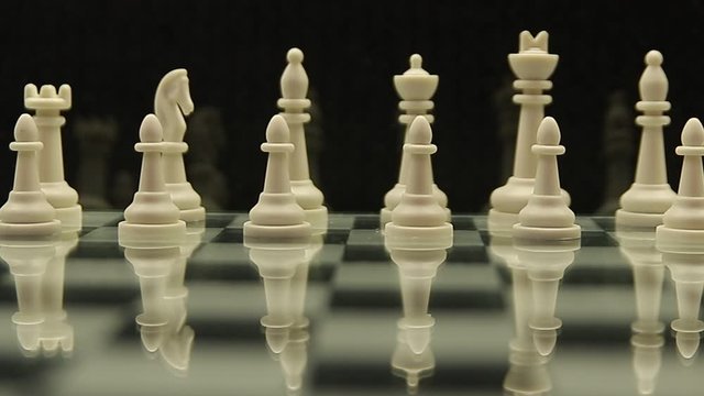 camera movement on a chessboard with white chess pieces on a black background