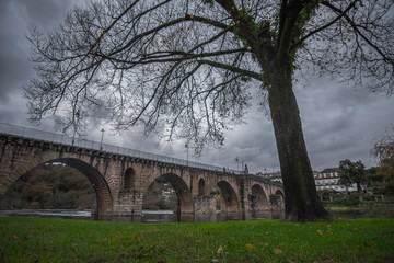 Fototapeta premium old stone bridge in park in rainy day