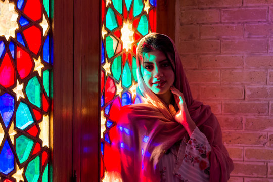 Shiraz, Iran - 31 January 2019: A beautiful woman in the famous Nasir-al-Molk mosque ( also called the Pink Mosque)