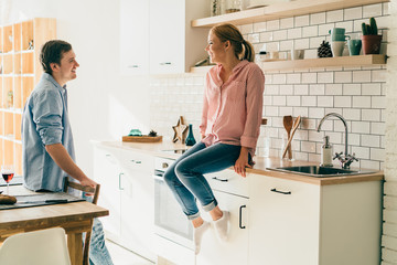 Cheerful young couple in kitchen